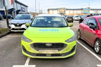 A driver in a Specsavers-branded car was mocked for parking across two bays in Norwich, with locals joking they "should've gone to Specsavers" for an eye test.