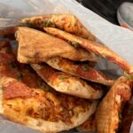 Woman shocked as Too Good To Go pizza arrives loose in plastic bag - viral TikTok sparks refund and apology after hygiene concerns over £3.70 order.