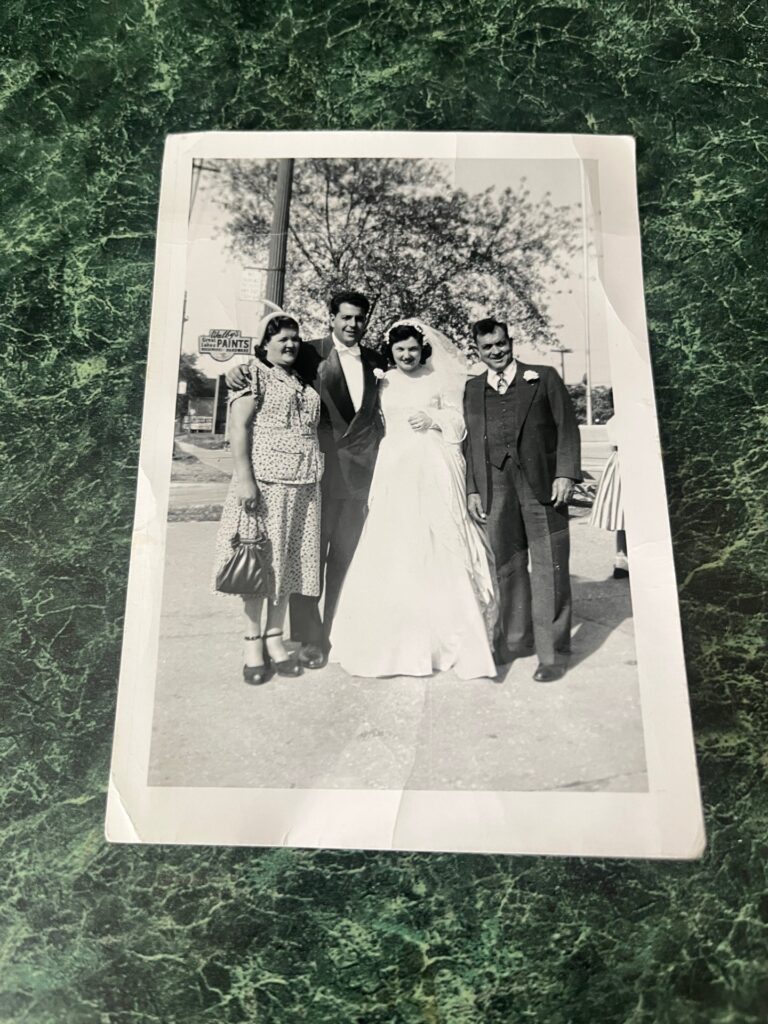 A 1953 wedding photo found in a donated book has been returned to the couple’s granddaughter, Sarah Ruggirello, after a library’s viral post helped track down the family.